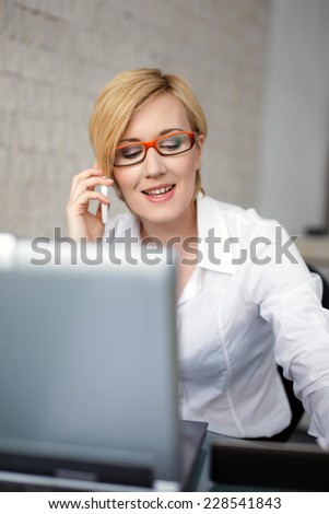 Blonde young successful manager calling in office