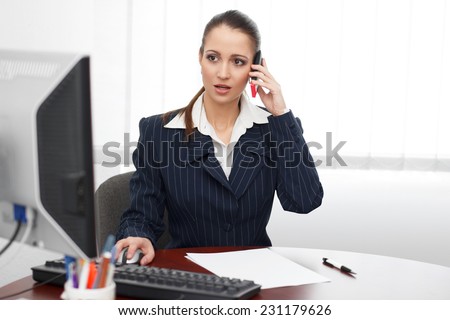Young brunette accountant calling client in office