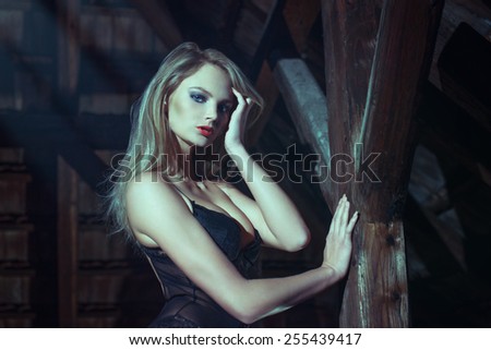 Sexy blonde woman at night in barn, sensuality