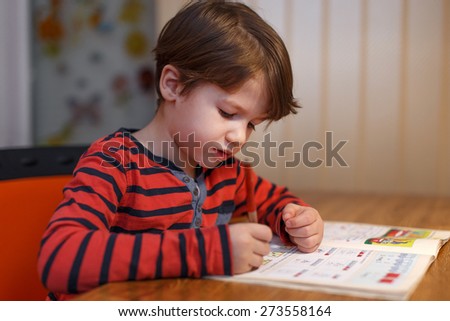 Little boy write maths exercise at home