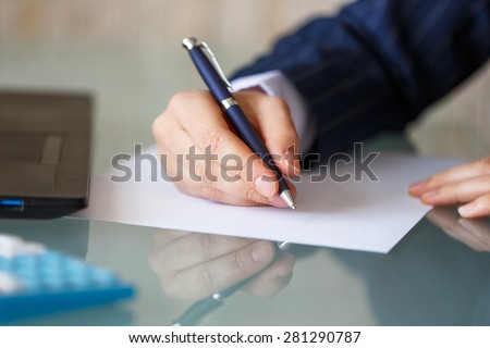 Businesswoman hand write on blank paper, closeup