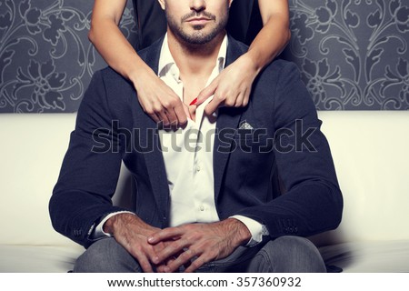 Woman hands undress man shirt from behind, vintage style