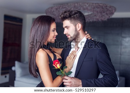 Young man give rose to lover indoor, couple in love
