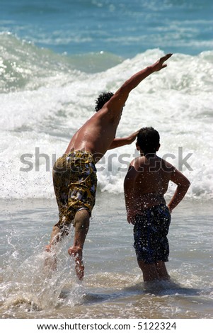 Acrobat jumping into the ocean