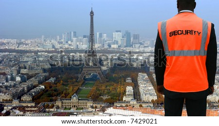 Security agent watching Paris from hilltop