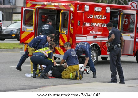 RESEDA, CALIFORNIA, USA - MAY 9: Firefighters help the victim of car accident on May 9, 2011 on Sherman Way in Reseda, California.