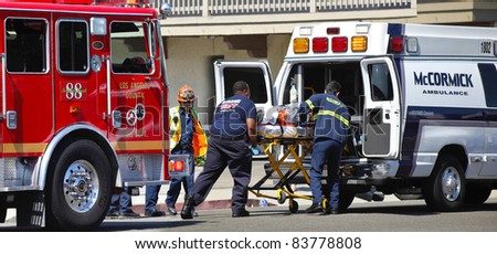 MALIBU, CALIFORNIA/USA - AUGUST 27, 2011: Unidentified firefighters help the victim of car accident on Pacific Coast Highway on August 27, 2011 in Malibu, California