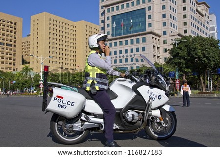 TAIPEI, TAIWAN -OCTOBER 20: An unidentified policeman from Taiwan rides a motorcycle during traffic control for a street parade, \