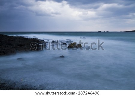 ocean with rocks under cloudy sky in Taiwan
