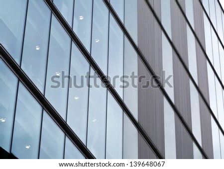 Abstract glass wall of office block; impersonal facade of city office block