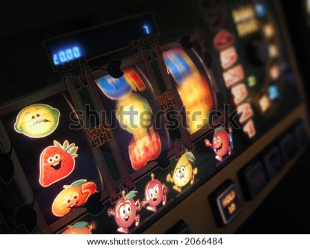 slot machine wheels spinning, reels brightly lit, differential focus