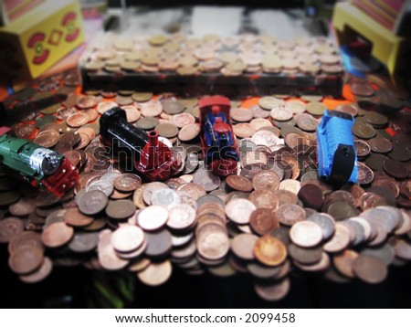 penny pusher or \'Penny Falls\' amusement machine, with prizes of toy locomotive engines