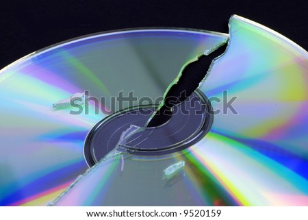 data loss -- broken CD or DVD isolated on black ground