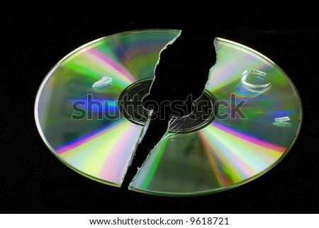 data loss -- broken CD or DVD isolated on black ground