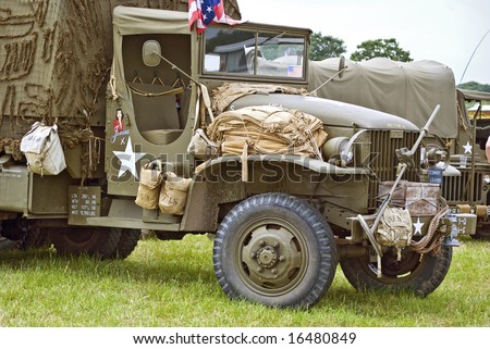 vintage American military vehicle hung with canvas kit-bags etc.