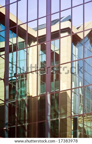 office block, London Docklands, reflected in the glass facade of another block