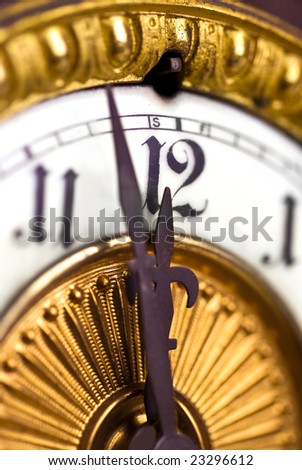 vintage clock face showing a few minutes to midnight; differential focus; \'New Year\'s Eve\'