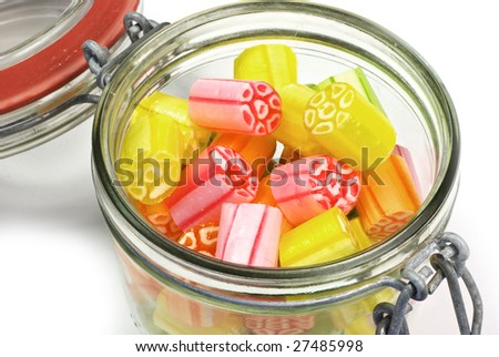 old-fashioned sweets (edwardian rock) in old-fashioned jar; lid closed; isolated on white ground