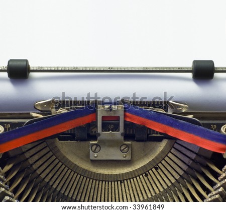 writers' block: vintage typewriter with blank paper; good copy-space in paper area - put your own message in a typewriter font