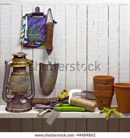 shelf of junk and gardening implements in shed; good copy-space