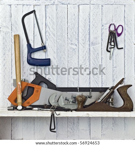 Do it Yourself (DIY) tools on workshop shelf; good copy space on white-painted wall