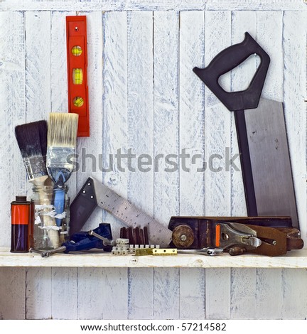 Do it Yourself (DIY) tools on workshop shelf --  good copy space on white-painted wall