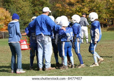Youth Football Huddle with Coach