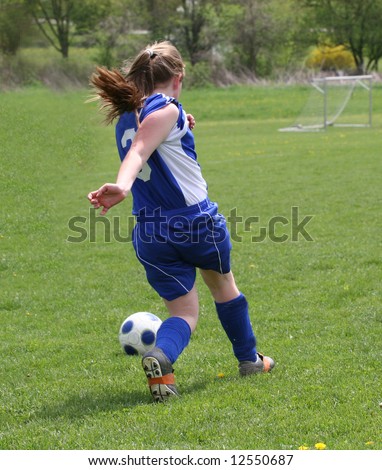 Teen Youth Soccer Player in Action on Field