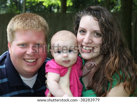 Happy Family of Three - Couple with Baby