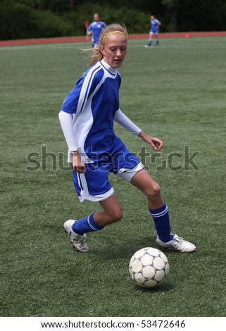 Teen Girl Chasing Soccer Ball