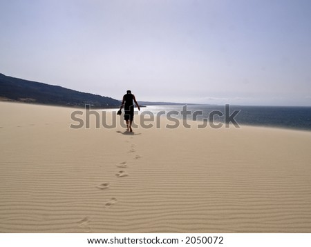 woman walking in sand dune