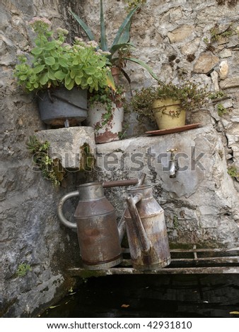 old jar in public fountain in Brantes, France
