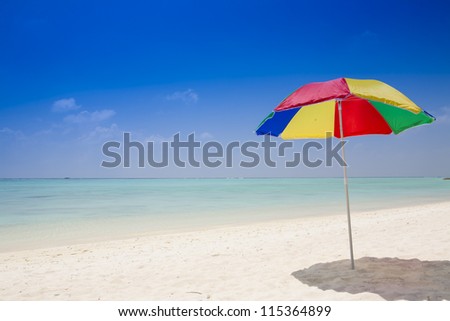 beach with a sunshade under a deep blue sky