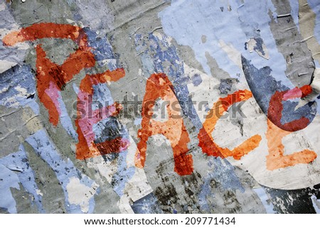 old grungy blue and grey  billboard with the word peace in red color