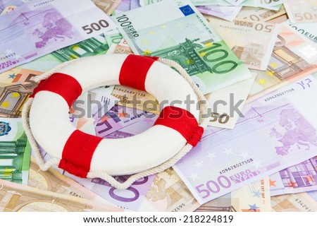 red and white life-saver on Euro banknotes, concept for Euro crisis, cut in interest rates