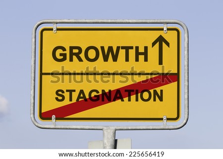 Blue sky behind a yellow city limit or place name sign informing with an arrow that you are on the way to growth and leaving stagnation