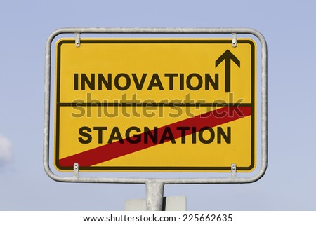 Blue sky behind a yellow city limit or place name sign informing with an arrow that you are on the way to innovation and leaving stagnation