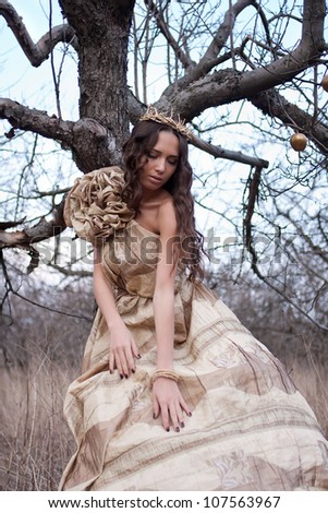Princess in gold dress in the forest