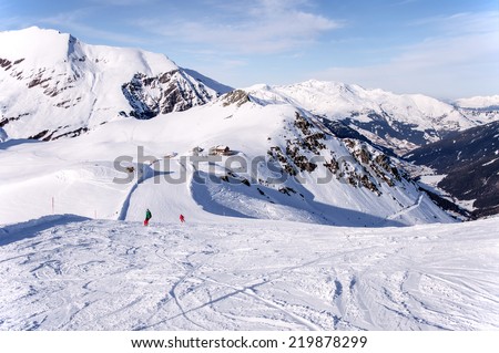 Zillertal Alps in Austria, ski piste, hut and Tuxtal valley viewed from the summit of Tuxkogel mountain at sunset light in winter