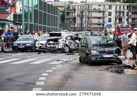 CRACOW, POLAND - MAY 19, 2015: Car accident when a truck ran between two rows of cars waiting at red light at the crossroads. 19 cars were damaged, 15 people were injured.
