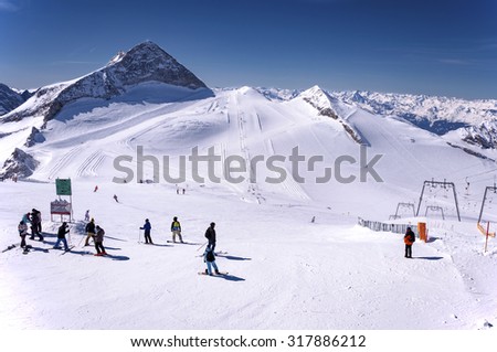 HINTERTUX, AUSTRIA â?? MARCH 13, 2012: Hintertux Glacier with skiers, snowboarders, ski runs, pistes and ski lifts in Zillertal Alps in Austria