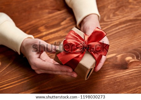 hands holding craft gift box