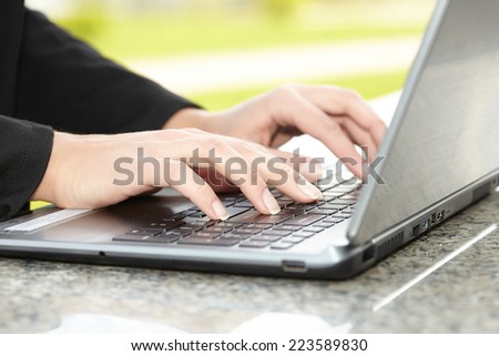 female hand writing on laptot
