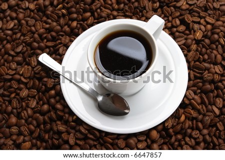 Cup with coffee, costing on coffee grain