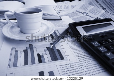Cup of fragrant coffee on a morning paper business news