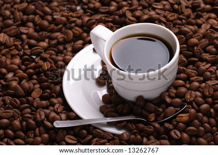 Cup with coffee costing on coffee grain Cup with coffee costing on coffee grain