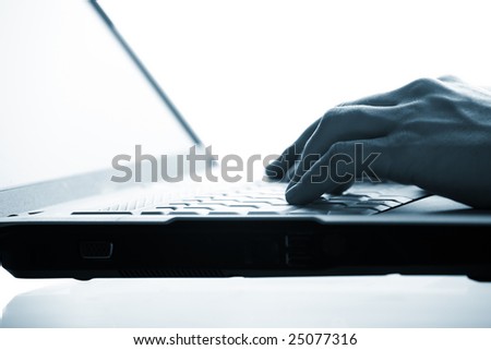 Close-up of  hand touching computer keys during work