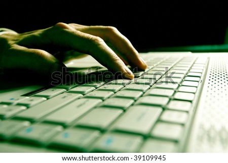 Close-up of  hand touching computer keys during work