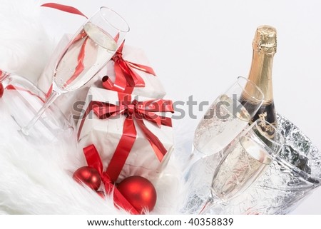 Christmas gift with tapes and a bottle of champagne