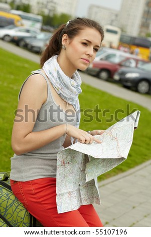 traveler girl searching for her destination on the map